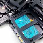 stack of internal hard drives on white surface